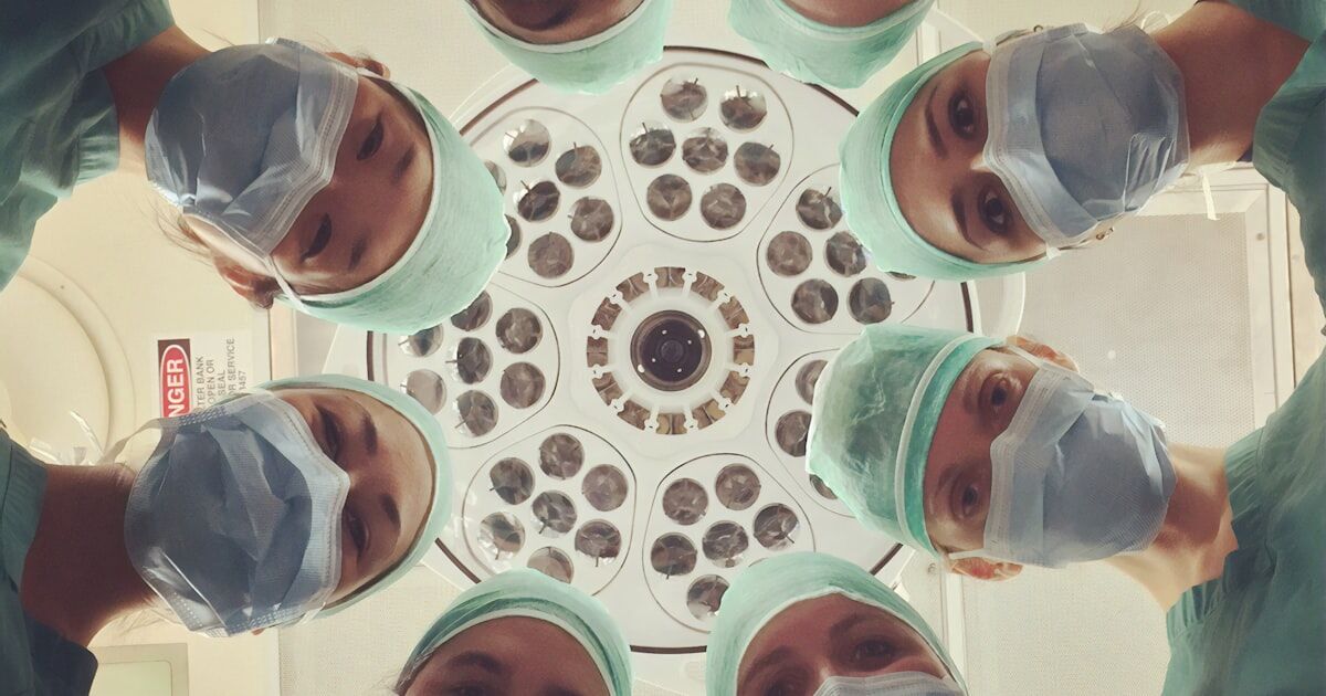 Person organizing daily medications for chronic condition management