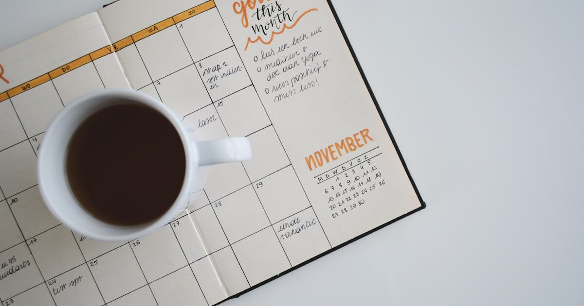 A clearly organized daily medication schedule laid out on a kitchen counter next to a glass of water and pill bottles