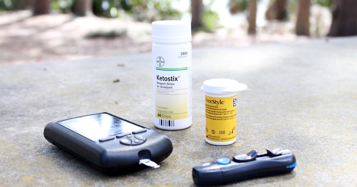 Diabetes medication supplies including insulin pen and glucose monitor with a phone showing medication reminders