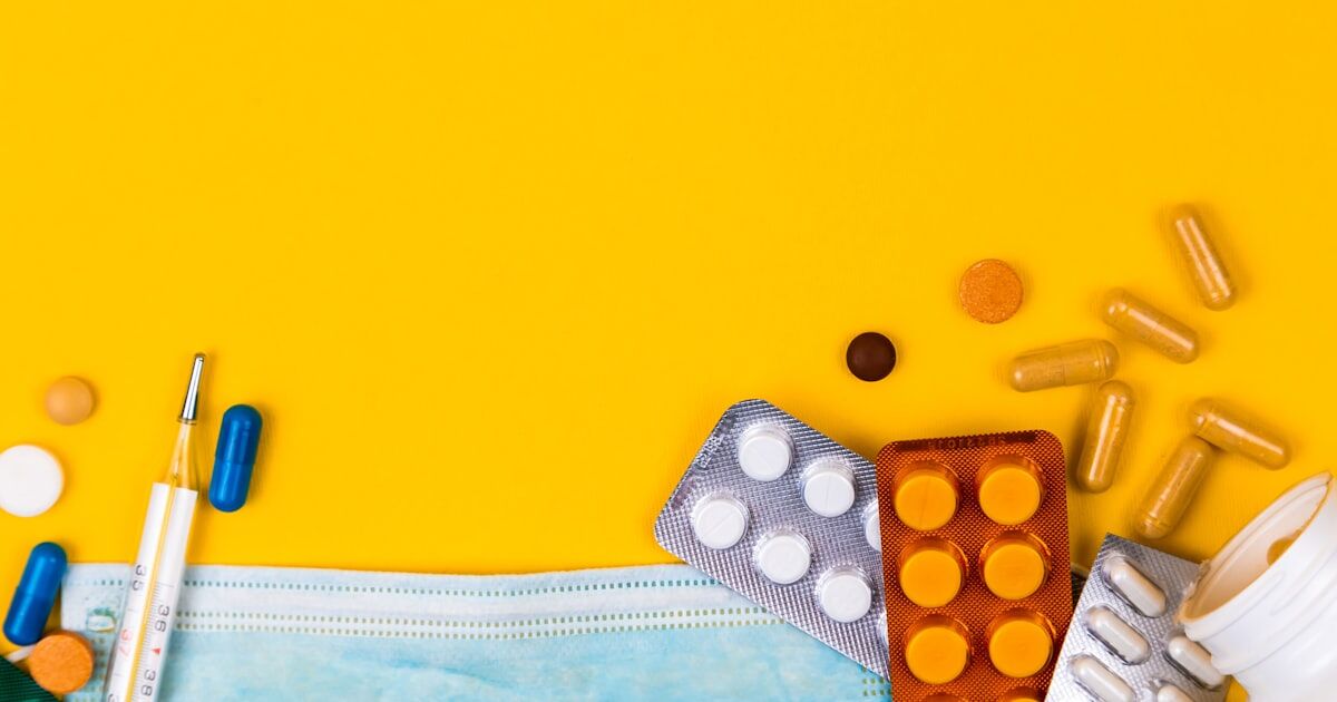 Close-up of a prescription medication label with dosage instructions highlighted alongside a glass of water and food